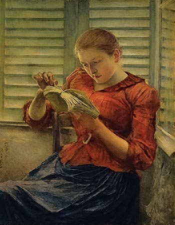women in red shirt reading a book