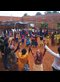 Villagers, both Tutsi and Hutu, gather to celebrate at the building site of a community center