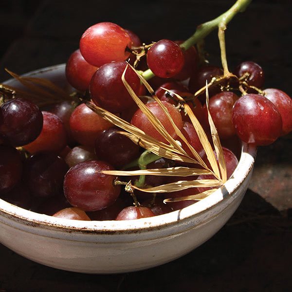 red grapes in a white bowl