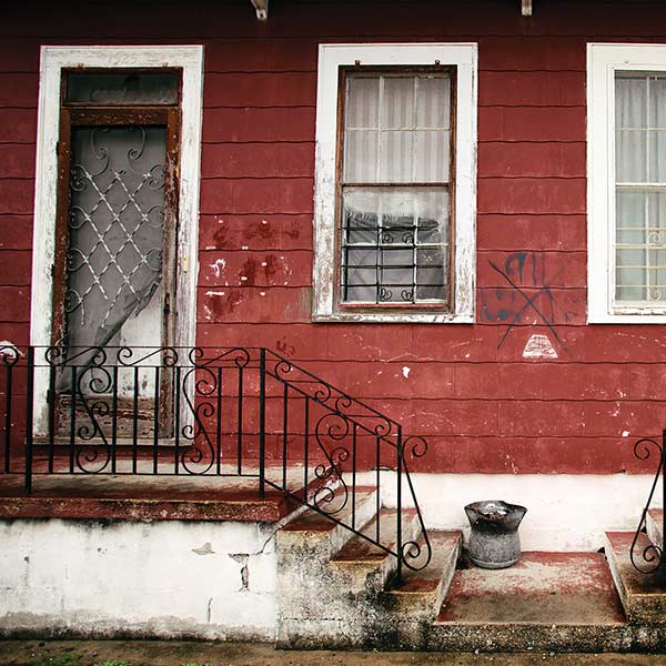 Steps in front of a row house with grafitti in the city 