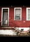 Steps in front of a row house with grafitti in the city