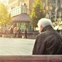 sad man sitting on park bench