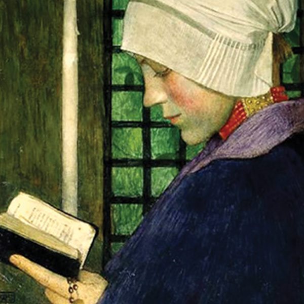 woman reading by candle light