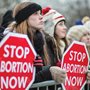 A line of women holding signs at a pro-life rally