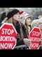 A line of women holding signs at a pro-life rally