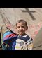 a refugee child with a tent in the background