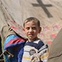 a refugee child with a tent in the background