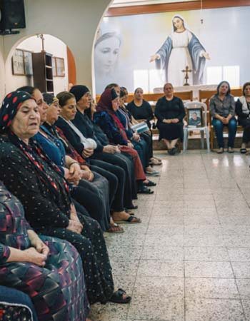 Christian women gather at a church in Erbil, Iraq, 