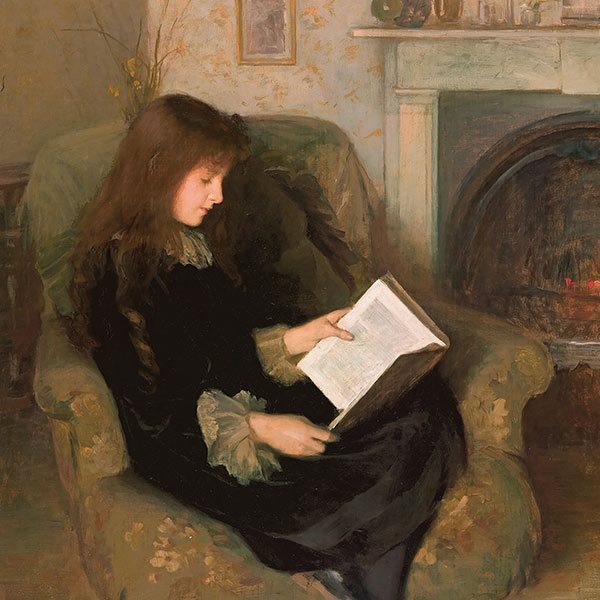 a girl reading on a sofa