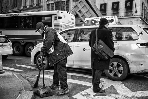 Man sweeping the street in New York City
