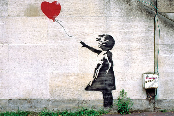 Banksy graffiti of a girl with a red balloon.