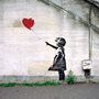 Banksy graffiti of a girl with a red balloon.