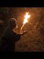 a man in a cave with a torch