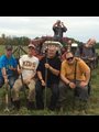 happy farmers posing with pitchforks