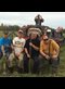 happy farmers posing with pitchforks