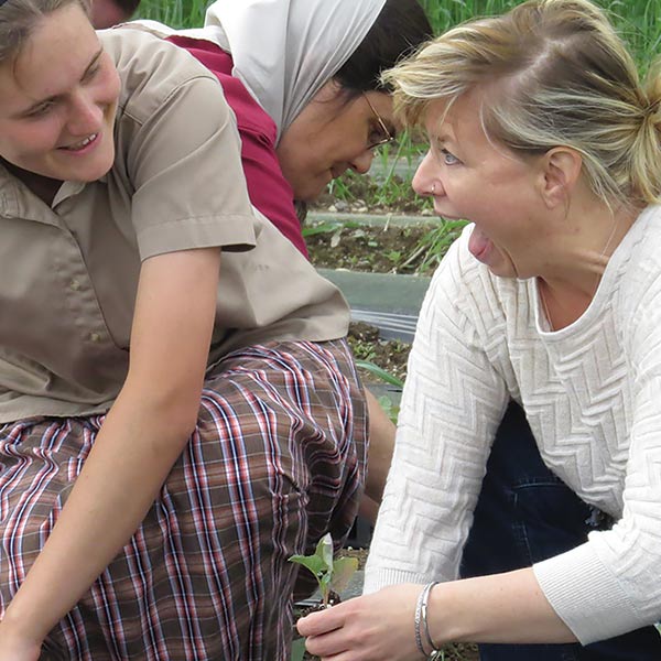women planting broccoli