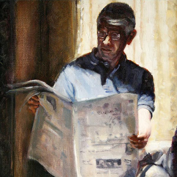 Man reading a newspaper in the afternoon sunlight