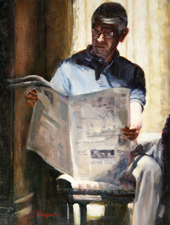man reading a newspaper in the afternoon sunlight