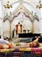 a young girl sleeping on a mattress in a church