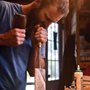 man using a chisel in a wood shop