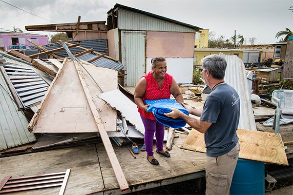 Samaritans Purse worker distributing supplies to a woman in Puerto Rico
