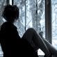Girl in high heels sitting on a windowsill and looking out.