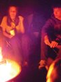 teenagers around a campfire in the dark