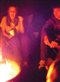 teenagers around a campfire in the dark