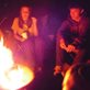 teenagers around a campfire in the dark