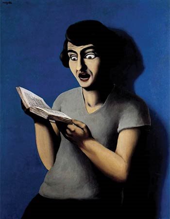 a woman looking surprised at a book and leaning against a blue wall