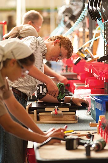 several Bruderhof members working in a community workshop