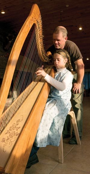 Marlys and her father enjoy their new harp