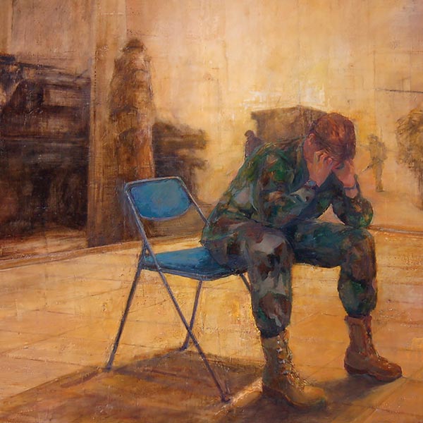 a soldier sitting on a chair with his head in his hands