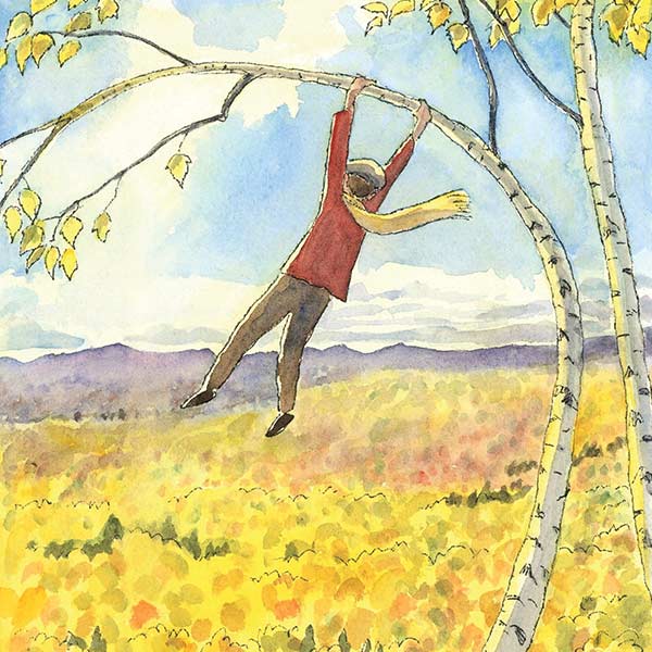 boy swinging on a birch tree in the fall