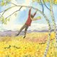 boy swinging on a birch tree in the fall