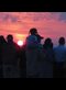 silhouettes of people in front of a sunrise