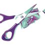 a pair of scissors next to cut up photographs of a baby