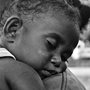 a toddler sleeping on her mothers shoulder