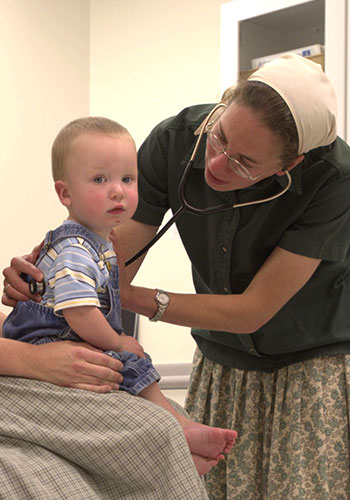 a Bruderhof doctor with a young patient