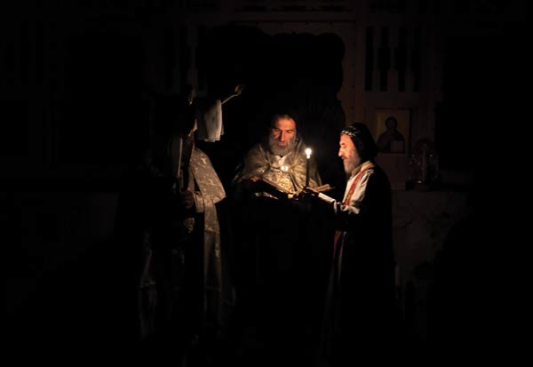 Easter Vigil, four a.m. The first text is read in the dark before Mass is celebrated. Photographs reproduced by permission of Cécile Massie
