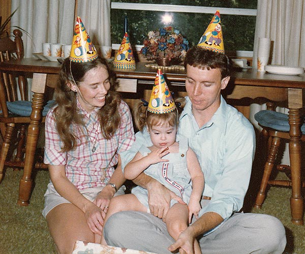 the author on her second birthday with her parents