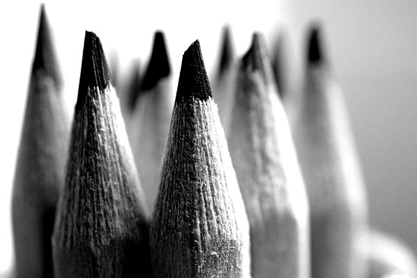 a black and white photograph of sharpened pencils