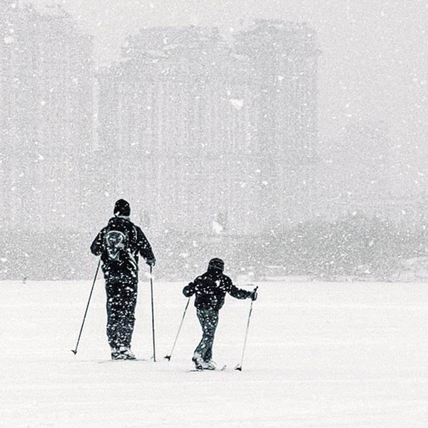 a man and a boy skiing in the snow
