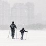 a man and a boy skiing in the snow