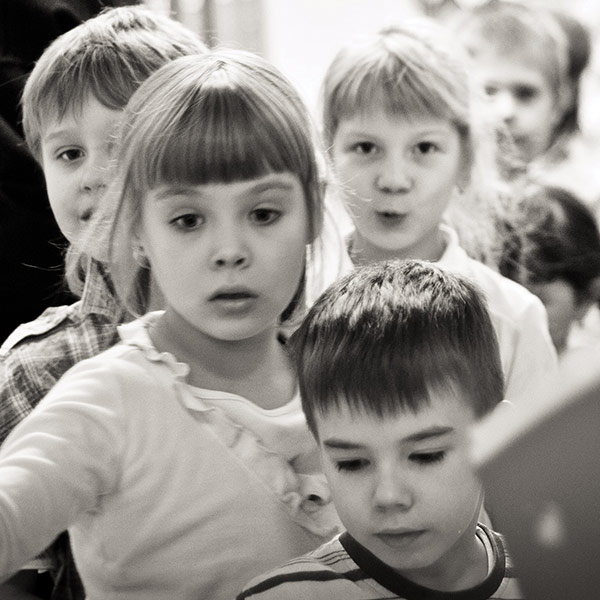 a line of children entering a door