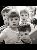 a line of children entering a door