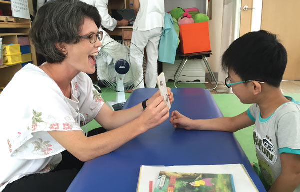 Joy Yoon instructs a child with cerebral palsy.