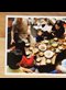 photograph on a wooden table of families eating a Korean meal