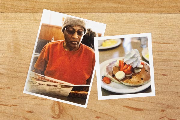 two photos on a wooden table, one of a man reading the paper, and the other of a plate of pancakes