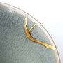 Kintsugi by Natsuyo Watanabe: a gold-plated repair in a grey ceramic dish